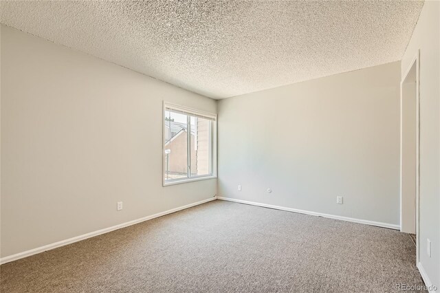 10712 E Exposition Ave Unit 209, Aurora, CO 80012 - empty room featuring a textured ceiling, carpet flooring, and baseboards