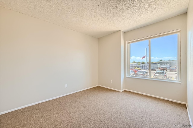 10712 E Exposition Ave Unit 209, Aurora, CO 80012 - spare room with carpet, a textured ceiling, and baseboards