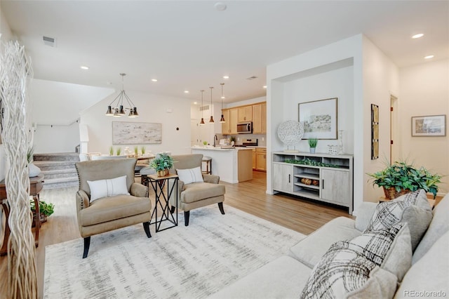 2463 Alpine St, Longmont, CO 80504 - living room featuring light wood-style flooring, stairway, and recessed lighting