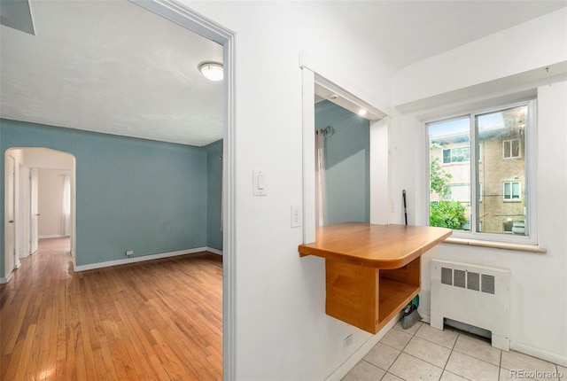 665 Washington St Unit 5B, Denver, CO 80203 - kitchen with radiator, arched walkways, and wood finished floors