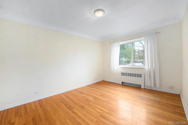 665 Washington St Unit 5B, Denver, CO 80203 - empty room featuring radiator and light wood-style floors