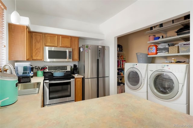 7520 W Coal Mine Ave Unit C, Littleton, CO 80123 - kitchen with stainless steel appliances, washing machine and dryer, light countertops, open shelves, and brown cabinetry