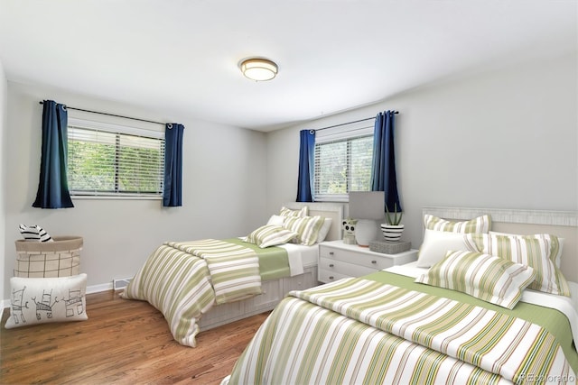 6330 E Vassar Ave, Denver, CO 80222 - bedroom with multiple windows and wood finished floors