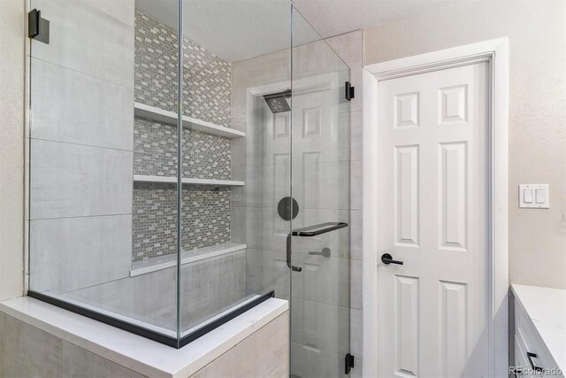 6330 E Vassar Ave, Denver, CO 80222 - bathroom with a stall shower and vanity