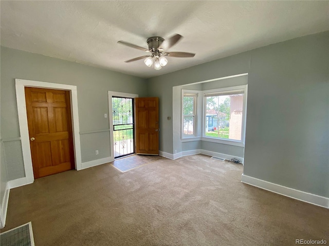 interior space with visible vents, baseboards, a healthy amount of sunlight, and a ceiling fan