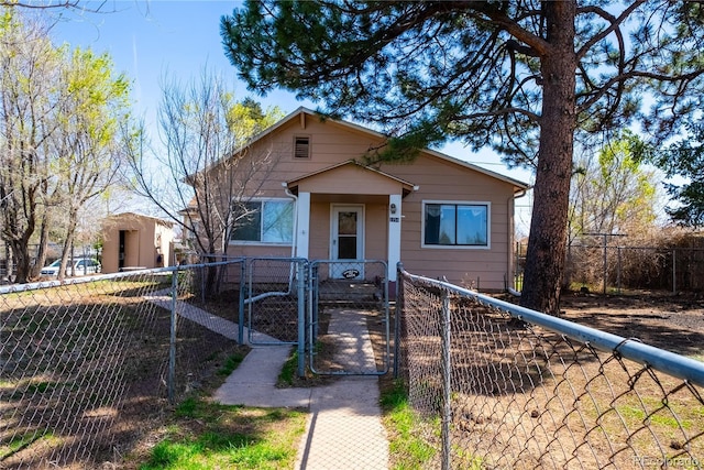 bungalow with a gate and a fenced front yard