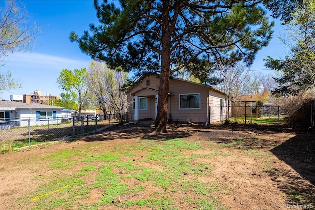 back of house featuring a fenced backyard