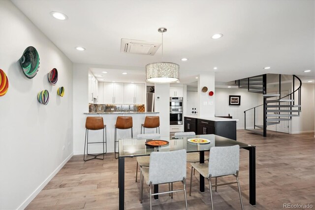 dining space featuring light wood-type flooring