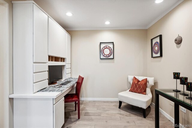 office area with crown molding and light hardwood / wood-style flooring