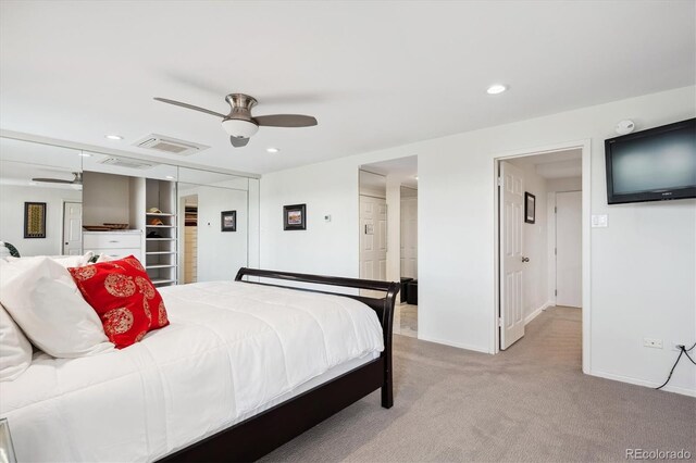 carpeted bedroom featuring ceiling fan and a closet