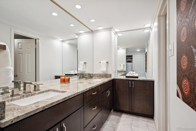 bathroom featuring ornamental molding and vanity