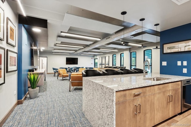 3131 E Alameda Ave Unit 1107, Denver, CO 80209 - kitchen featuring dishwasher, open floor plan, light stone counters, and pendant lighting