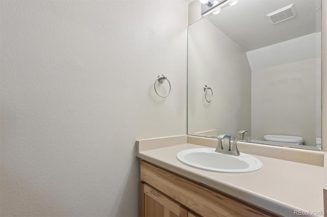 bathroom with vanity and toilet