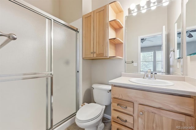 bathroom featuring ceiling fan, toilet, vanity, and walk in shower