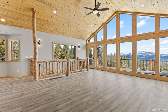 interior space featuring wood-type flooring, a mountain view, high vaulted ceiling, and wood ceiling