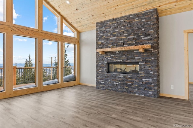 unfurnished living room with wood ceiling, high vaulted ceiling, a fireplace, and hardwood / wood-style floors