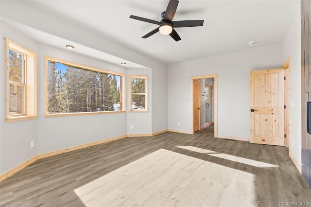 unfurnished bedroom with dark wood-type flooring and ceiling fan