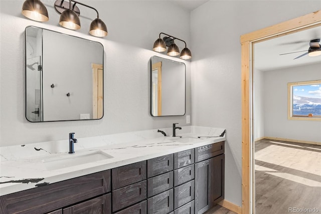 bathroom featuring vanity, hardwood / wood-style floors, and ceiling fan