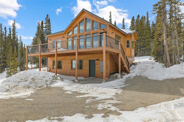 snow covered property featuring a deck