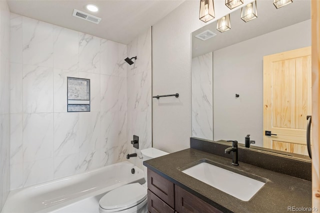 full bathroom with vanity, tiled shower / bath combo, and toilet