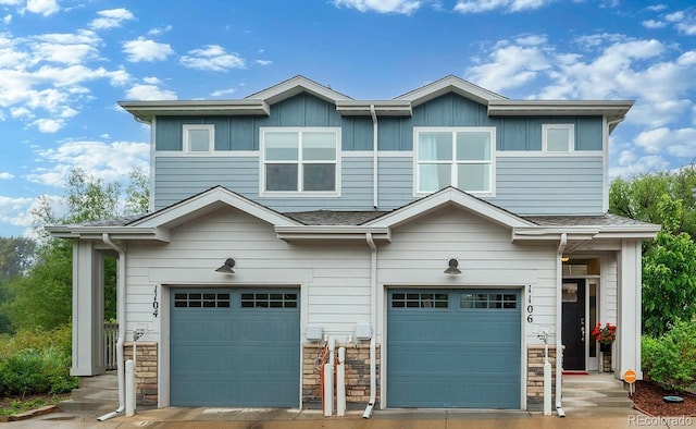 1106 Oak Cir, Lakewood, CO 80215 - view of front of home featuring a garage, stone siding, and board and batten siding