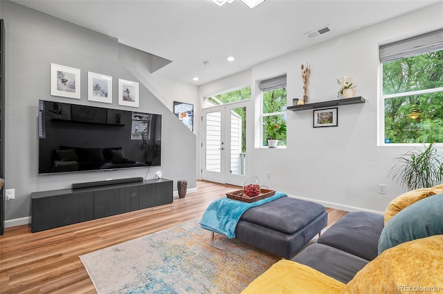 1106 Oak Cir, Lakewood, CO 80215 - living area with plenty of natural light, wood finished floors, french doors, and recessed lighting