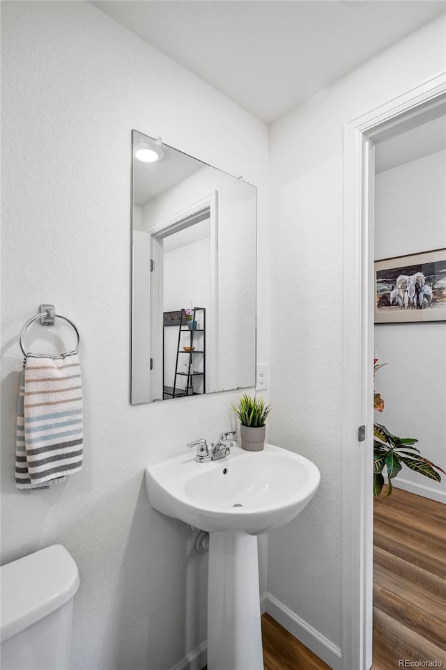 1106 Oak Cir, Lakewood, CO 80215 - half bath featuring wood finished floors and toilet