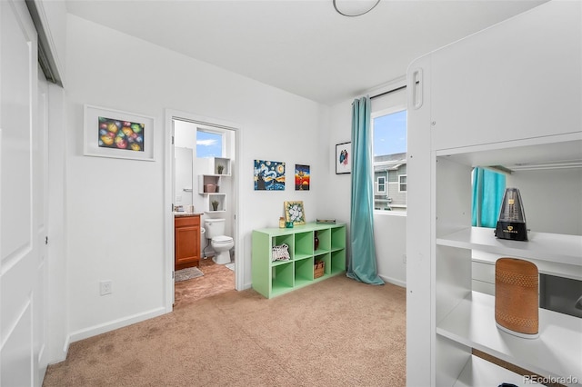 1106 Oak Cir, Lakewood, CO 80215 - bedroom with light colored carpet and connected bathroom
