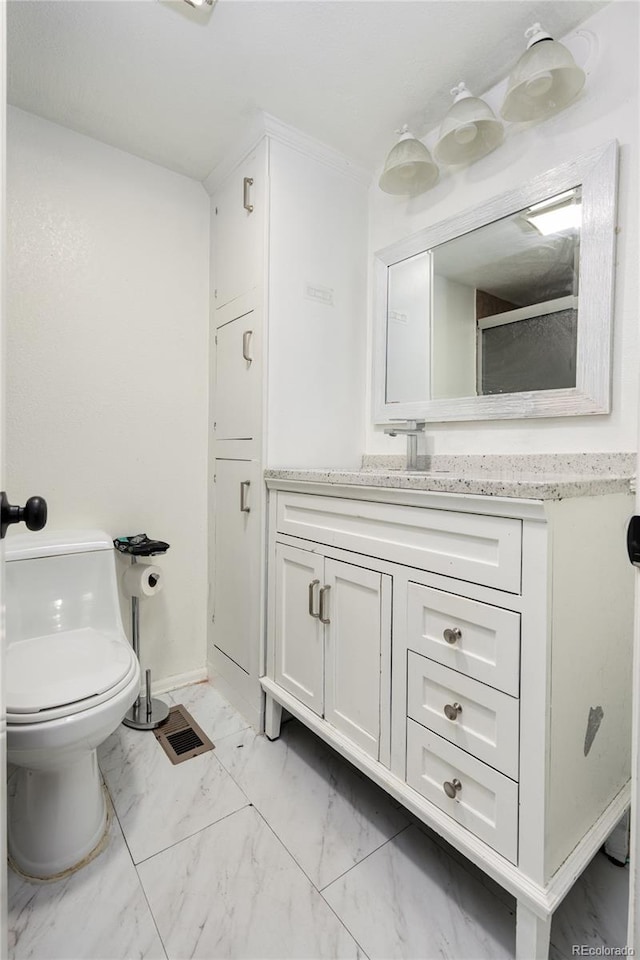 bathroom featuring vanity and toilet