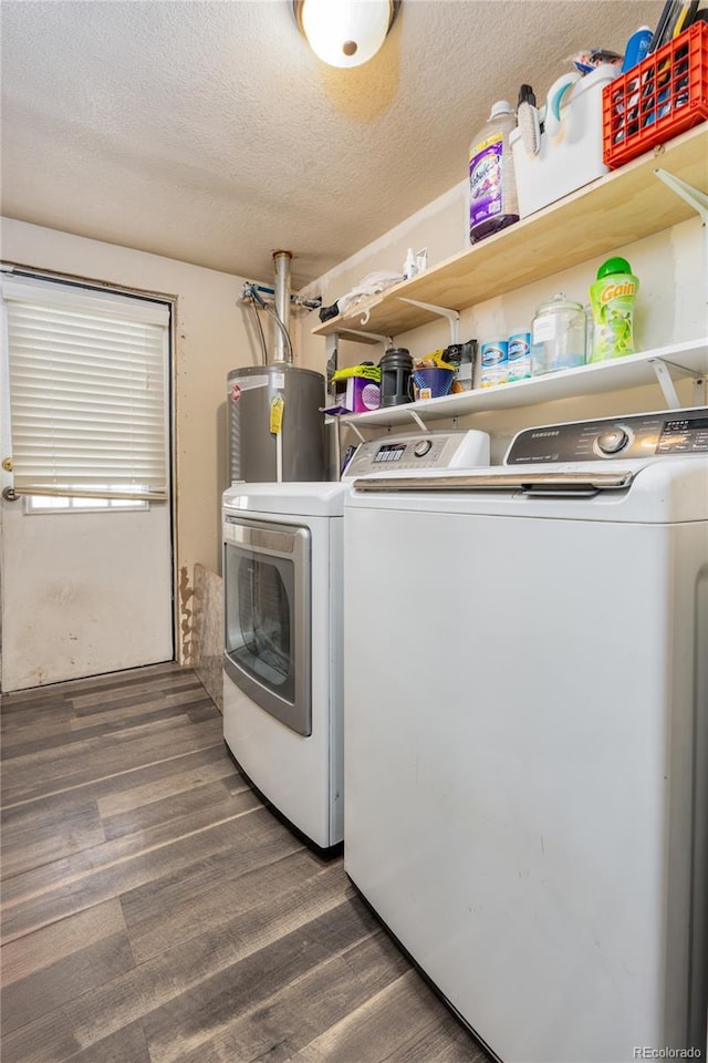 laundry room with gas water heater, washing machine and dryer, dark hardwood / wood-style floors, and a textured ceiling