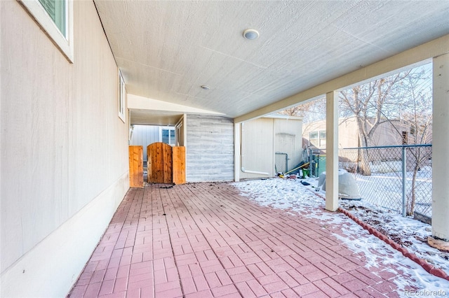 snow covered deck with a patio area