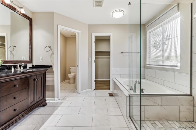 full bathroom featuring vanity, toilet, and independent shower and bath