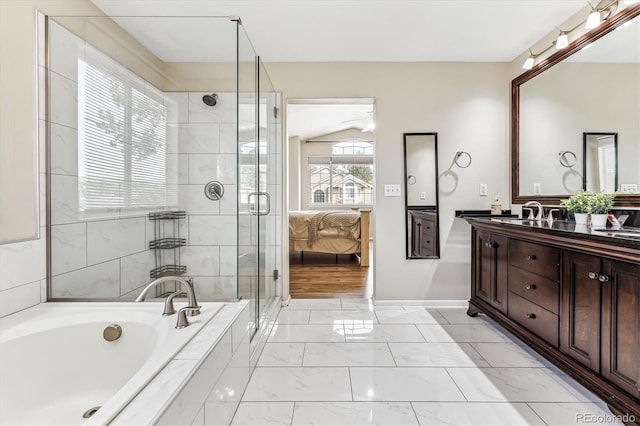 bathroom featuring plus walk in shower, vaulted ceiling, and vanity