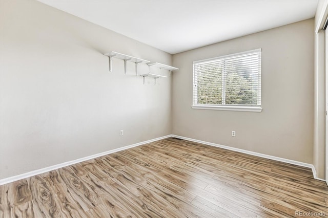 empty room with light hardwood / wood-style flooring