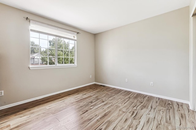 spare room featuring light hardwood / wood-style floors