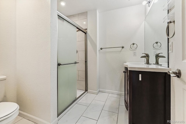 bathroom with toilet, a shower with door, and vanity