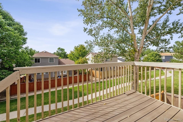 wooden terrace featuring a yard