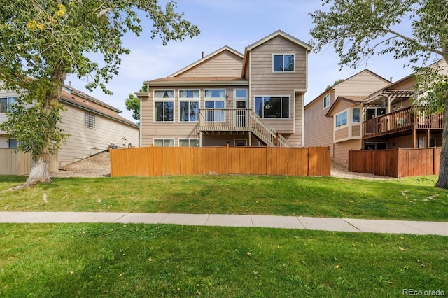 rear view of property with a lawn