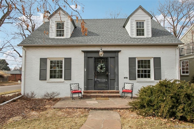 cape cod-style house with a patio area