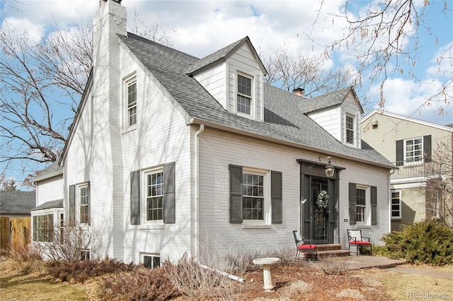 cape cod home with a patio