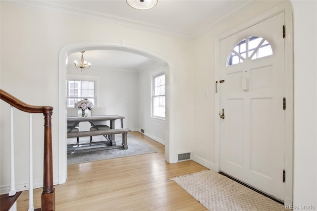 entrance foyer featuring light hardwood / wood-style flooring and ornamental molding