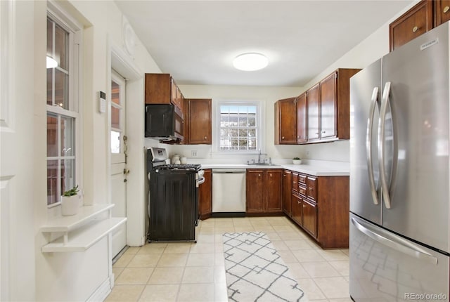 kitchen featuring sink, stainless steel appliances, and light tile patterned flooring