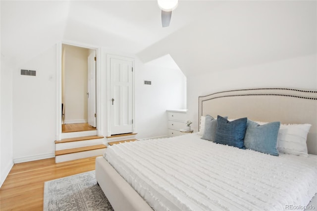 bedroom featuring vaulted ceiling, hardwood / wood-style floors, and ceiling fan