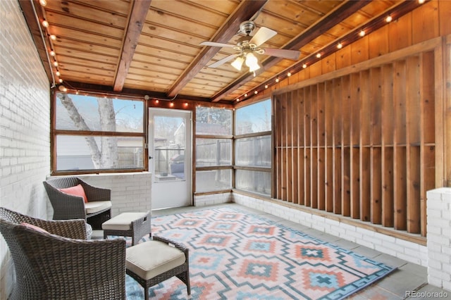 sunroom / solarium featuring beam ceiling, wooden ceiling, and ceiling fan