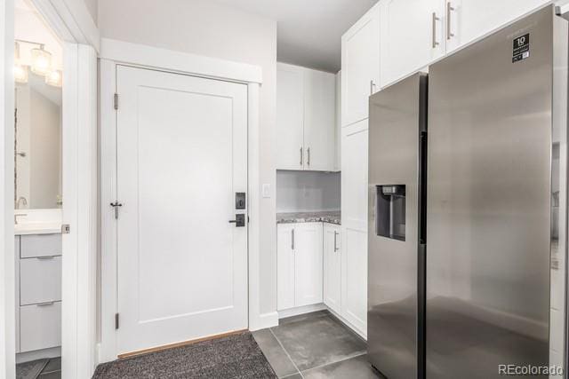 828 Grand Ave Unit 201C, Grand Lake, CO 80447 - kitchen featuring stainless steel refrigerator with ice dispenser, white cabinets, light countertops, and a sink