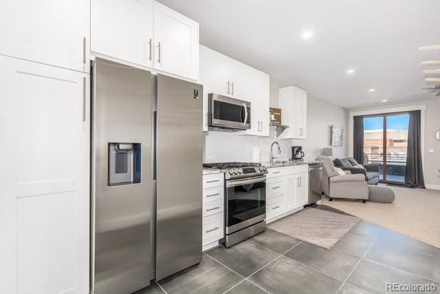 828 Grand Ave Unit 201C, Grand Lake, CO 80447 - kitchen with appliances with stainless steel finishes, open floor plan, white cabinetry, recessed lighting, and a sink