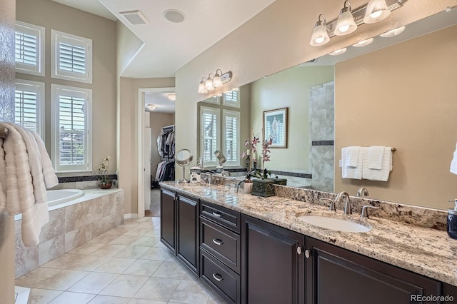3181 Firenze Pl, Highlands Ranch, CO 80126 - full bathroom featuring a garden tub, tile patterned floors, double vanity, and a spacious closet