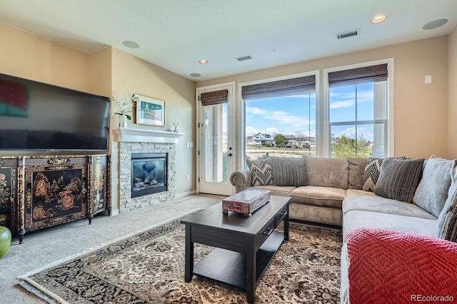 3181 Firenze Pl, Highlands Ranch, CO 80126 - living area featuring carpet floors, a stone fireplace, and recessed lighting