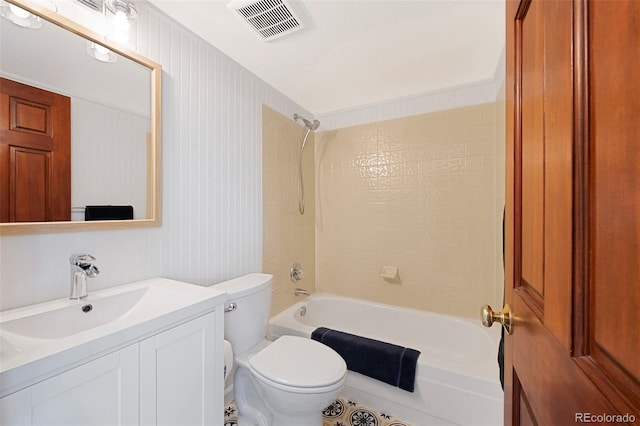 full bathroom with tiled shower / bath combo, vanity, and toilet