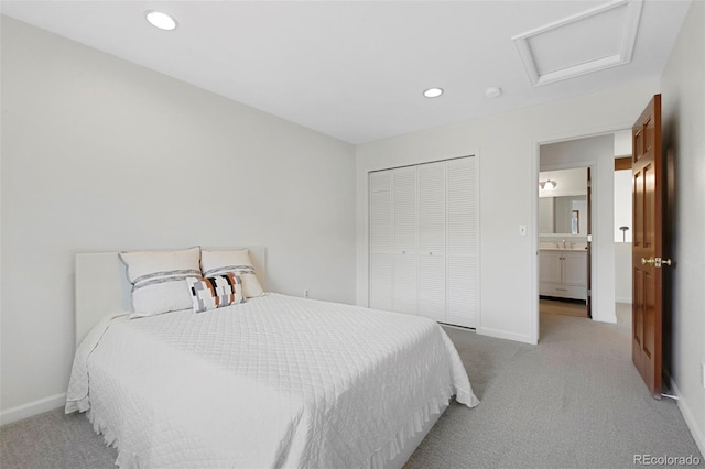 carpeted bedroom featuring sink and a closet